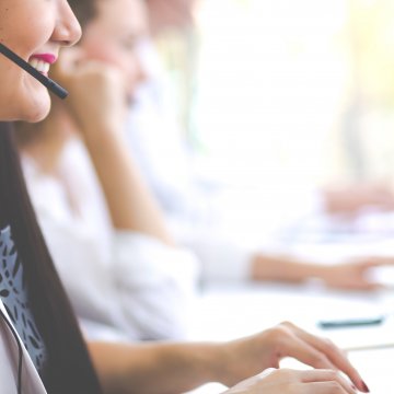 best voip service smiling women in office with headsets voip calling